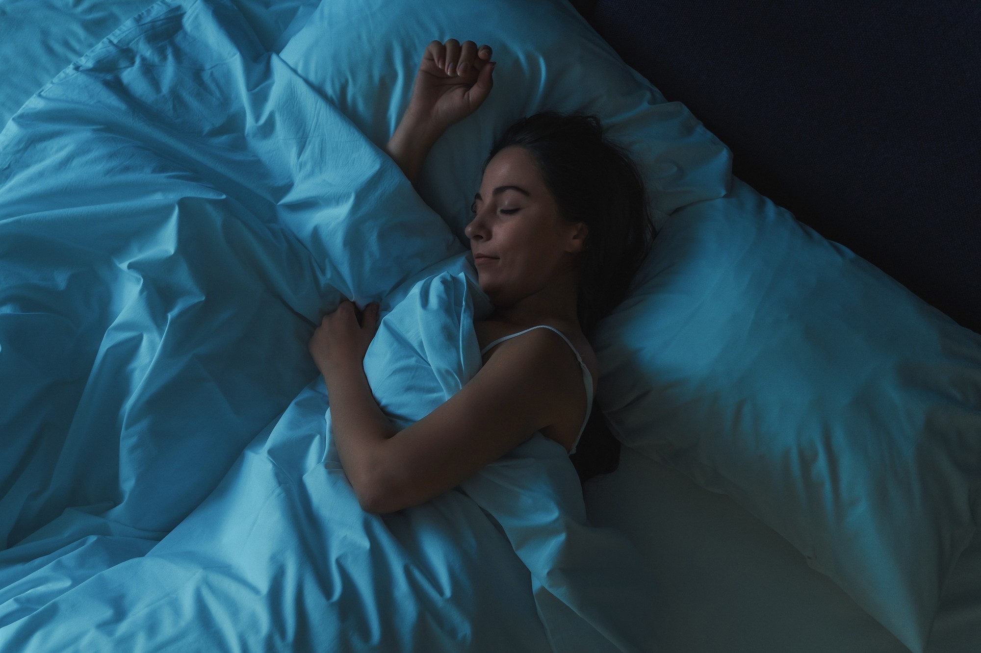Woman asleep in a darkened room