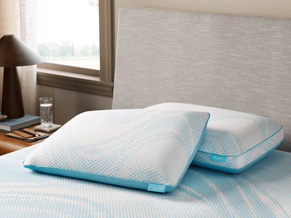 A Closeup of a TEMPUR-Breeze ProLo and ProHi Pillow on a TEMPUR-Breeze Mattress in a Styled Room