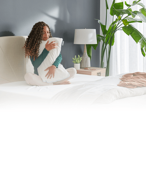 Woman on Mattress hugging tempur-pedic pillow
