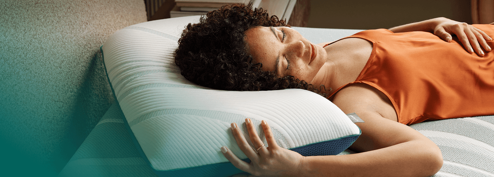 Woman sleeping on an Adapt mattress on an Adapt pillow