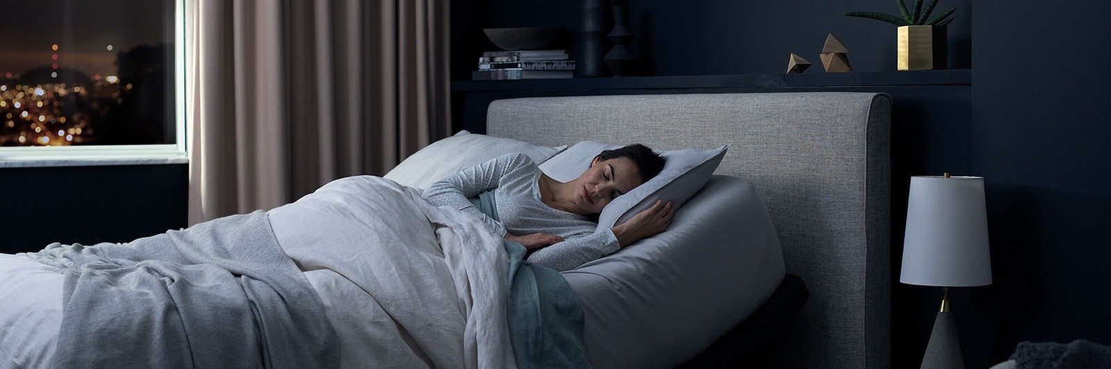 Woman sleeping in a bed with the base raised