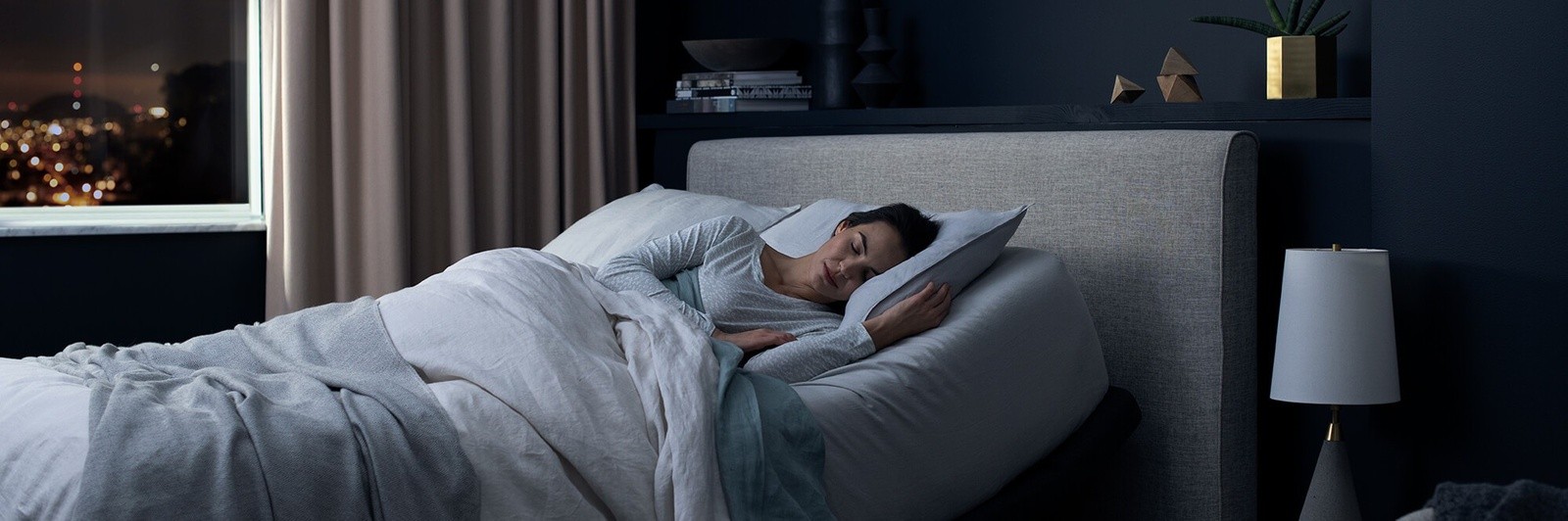 A woman sound asleep on a Tempur-Pedic mattress and adjustable power base