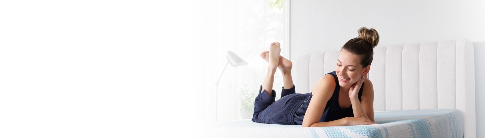 Woman smiling laying on a Tempur Pedic breeze mattress