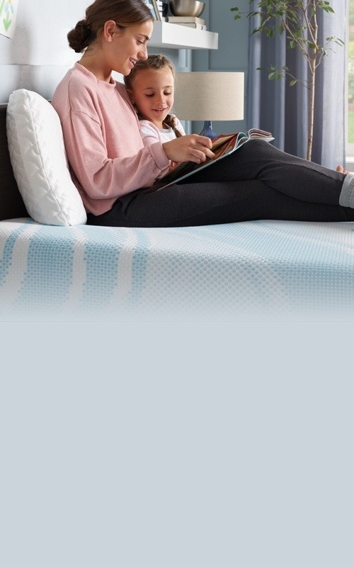 Woman reading with child on their Tempur mattress