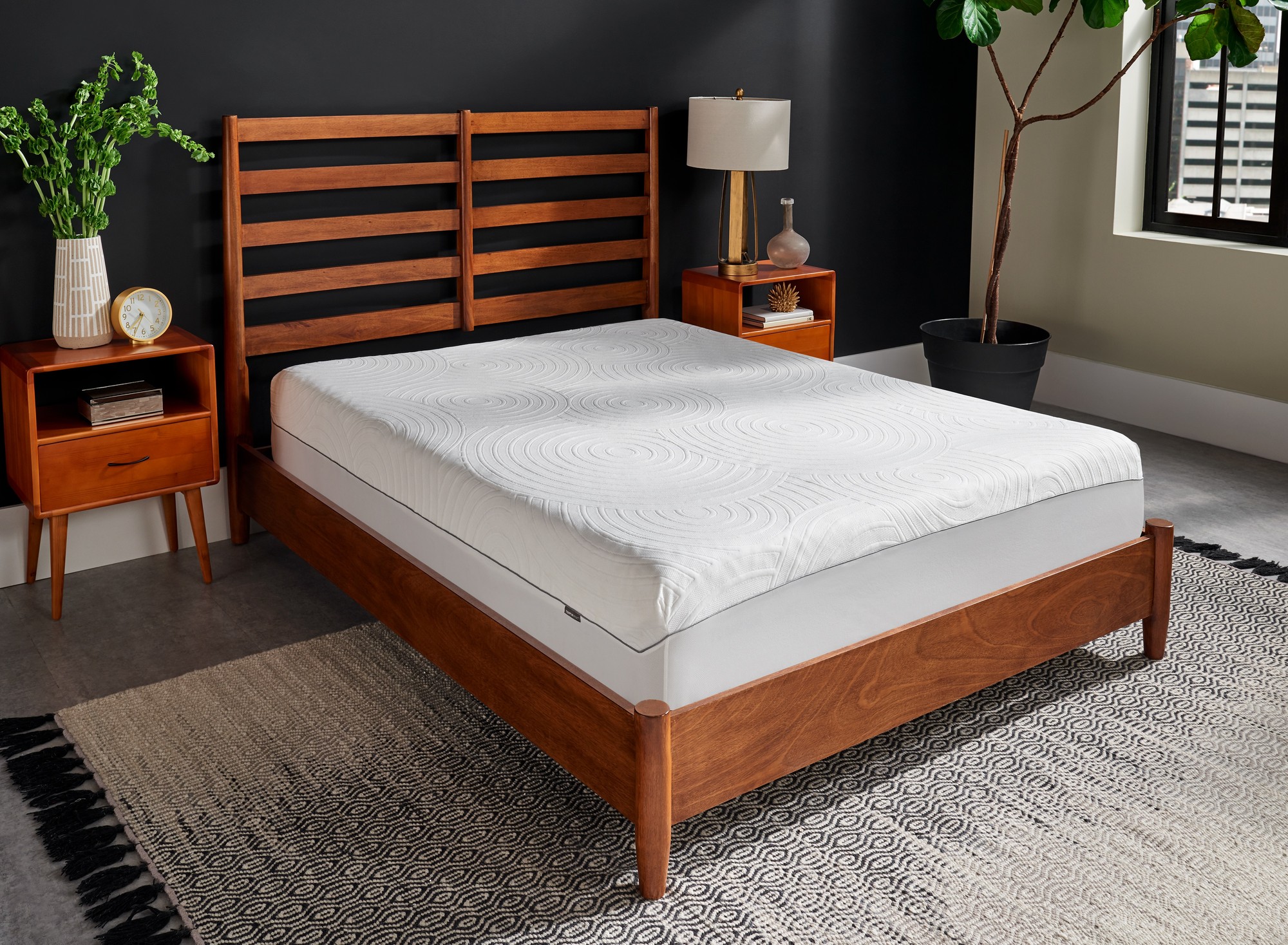 Mattress with tempur-mattress protector on wooden bedroom furniture in styled bedroom